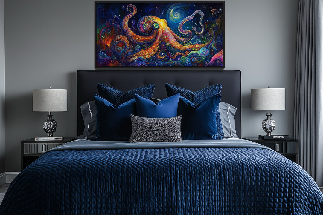 Psychedelic octopus framed canvas wall art hanging above a bed with blue bedding and lamps.