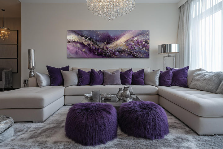 Horizontal purple abstract canvas print with gold accents hanging above a modern sectional sofa.
