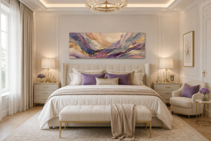Long horizontal abstract canvas wall art with purple and gold marble patterns above a bed.