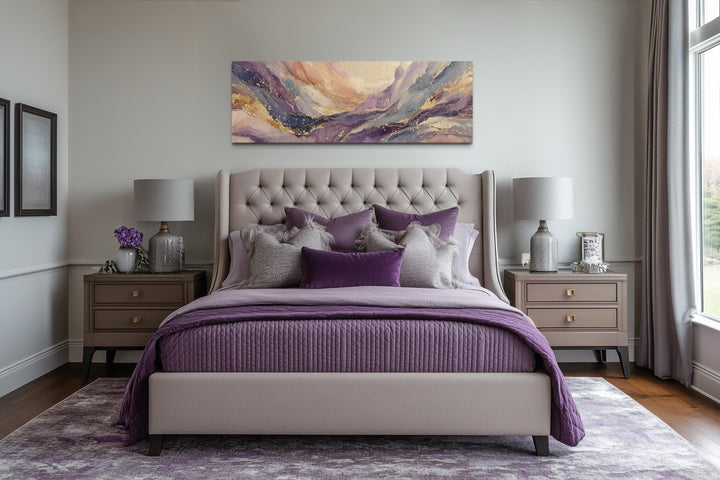 A long horizontal abstract canvas with purple and gold marble patterns hangs above a bed.