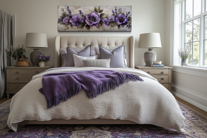 Panoramic framed canvas wall art featuring antique purple flowers displayed above a bed.