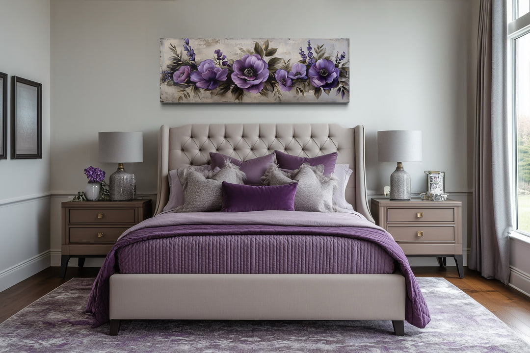 Panoramic framed canvas wall art featuring antique purple flowers displayed above a bed.