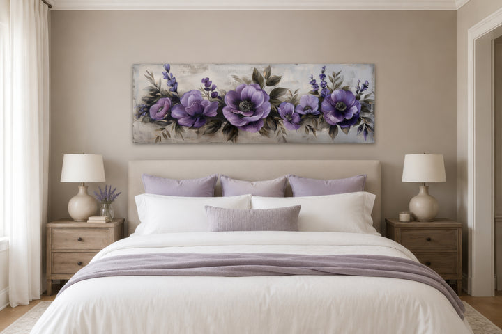 Panoramic framed canvas wall art featuring purple antique flowers hanging above a bed.