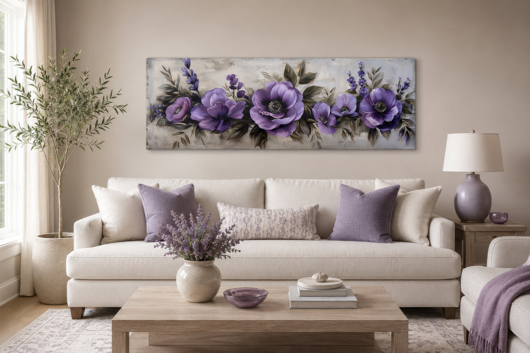 Panoramic framed canvas wall art featuring antique purple and lavender flowers above a sofa.