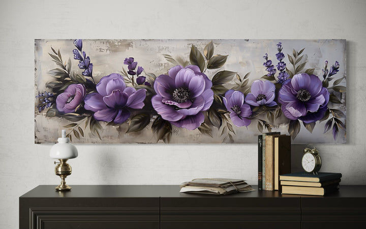 Panoramic framed canvas wall art featuring antique purple and lavender flowers above a dark dresser.