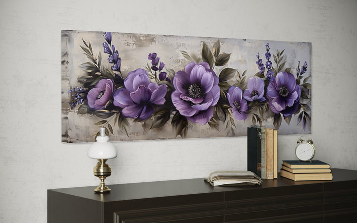 Panoramic canvas wall art featuring antique purple flowers above a dark wood dresser.