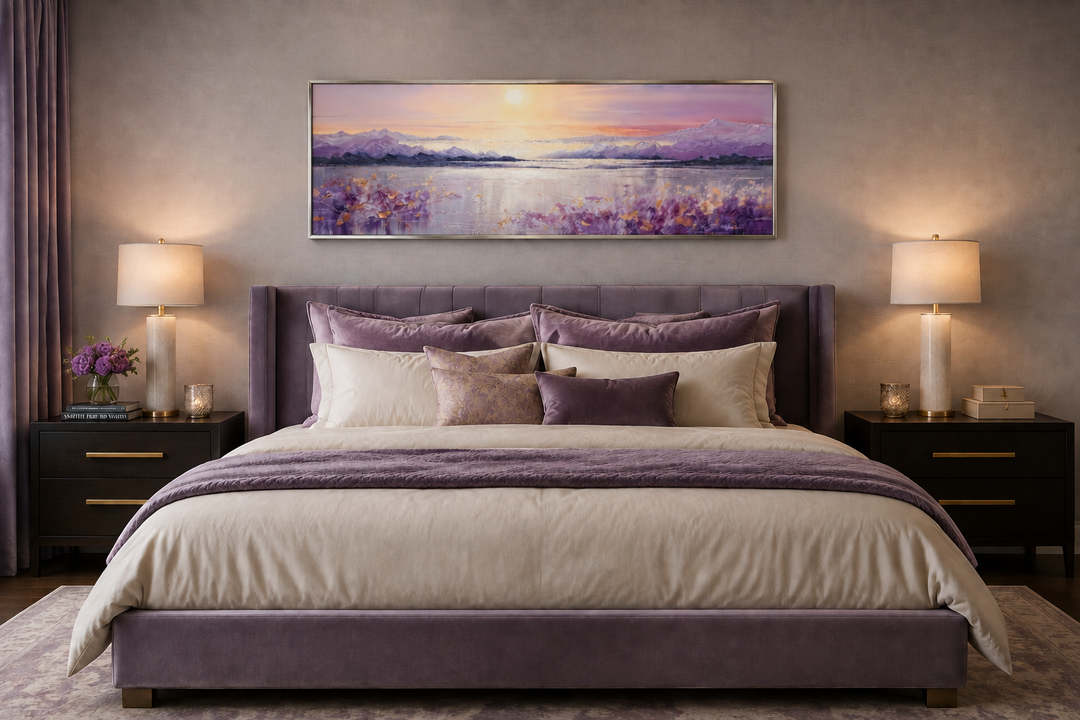 Long horizontal purple mountain lake sunset painting framed above a bed in a modern bedroom.