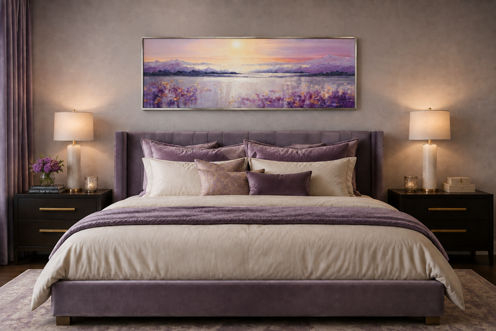 Long horizontal purple mountain lake sunset painting framed above a bed in a modern bedroom.