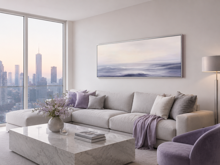 Purple Ocean Waves long horizontal coastal canvas wall art above a light gray sectional sofa.