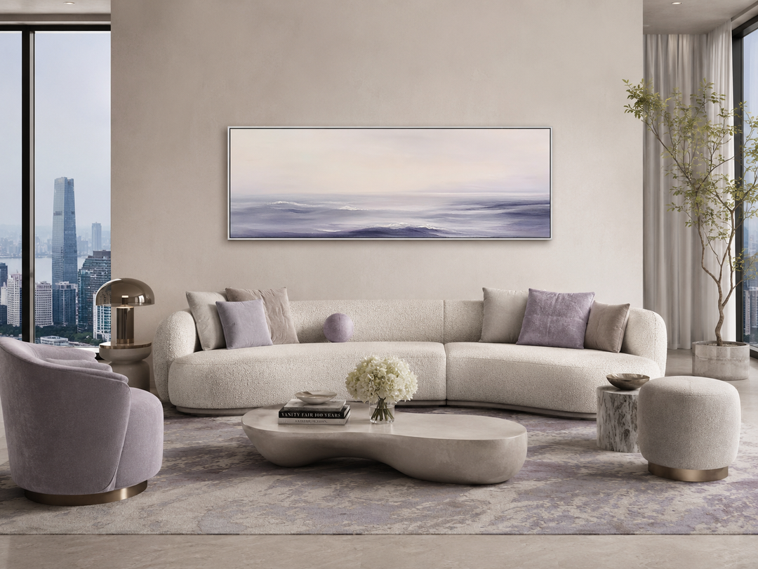 Purple Ocean Waves horizontal coastal canvas wall art above a modern curved sofa in a living room.