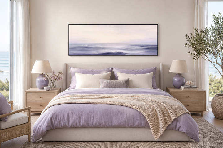 Purple Ocean Waves long horizontal coastal canvas wall art hanging above a bed in a serene bedroom.