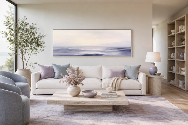 Purple Ocean Waves long horizontal coastal canvas wall art above a white sofa in a modern room.