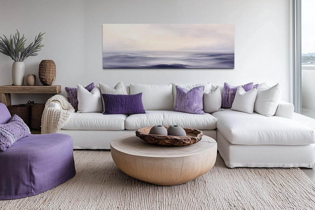 Purple Ocean Waves long horizontal coastal canvas wall art hanging above a white sectional sofa.