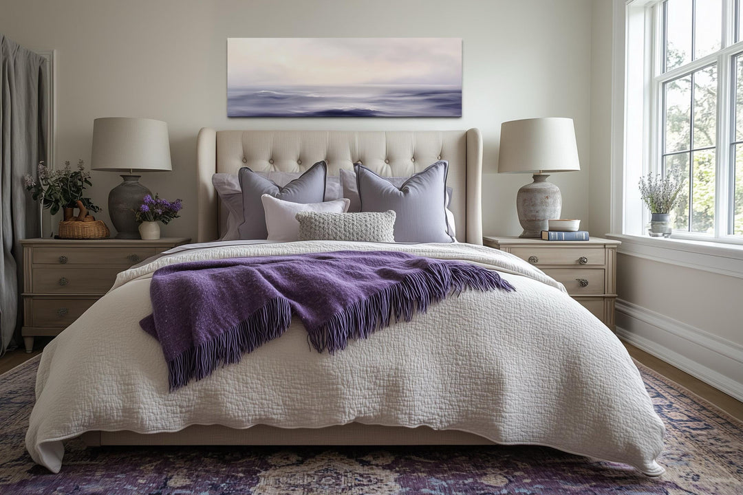 Purple Ocean Waves long horizontal coastal canvas wall art hanging above a bed in a bedroom.