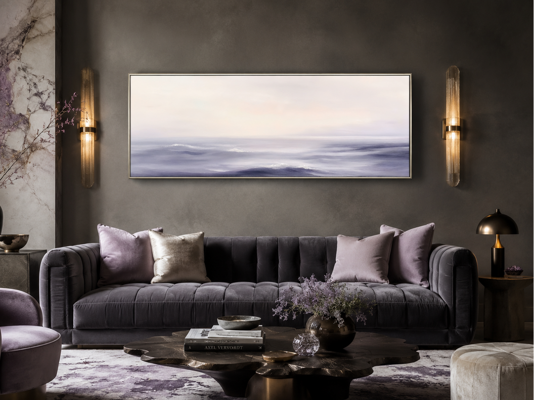 Purple Ocean Waves long horizontal coastal canvas wall art hanging above a modern tufted sofa.