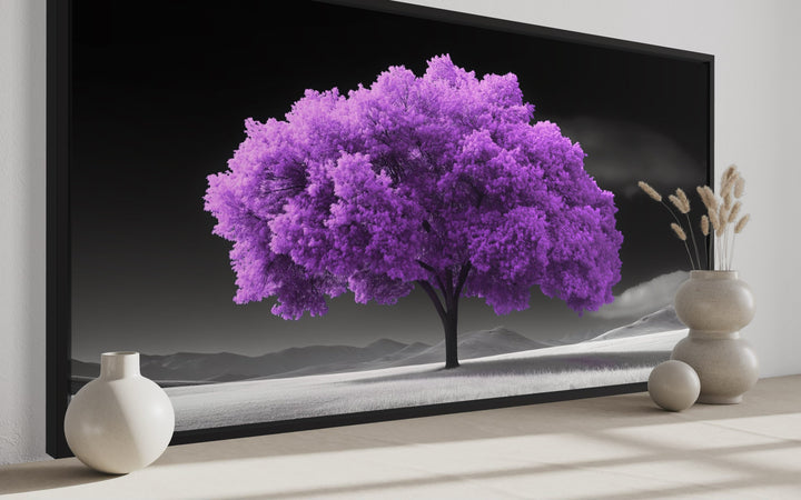 Framed canvas wall art featuring a vibrant purple tree on a black and white landscape background.