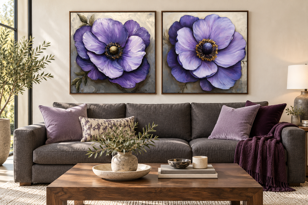 Set of 2 large purple flower framed canvas wall art pieces hanging above a gray sofa.