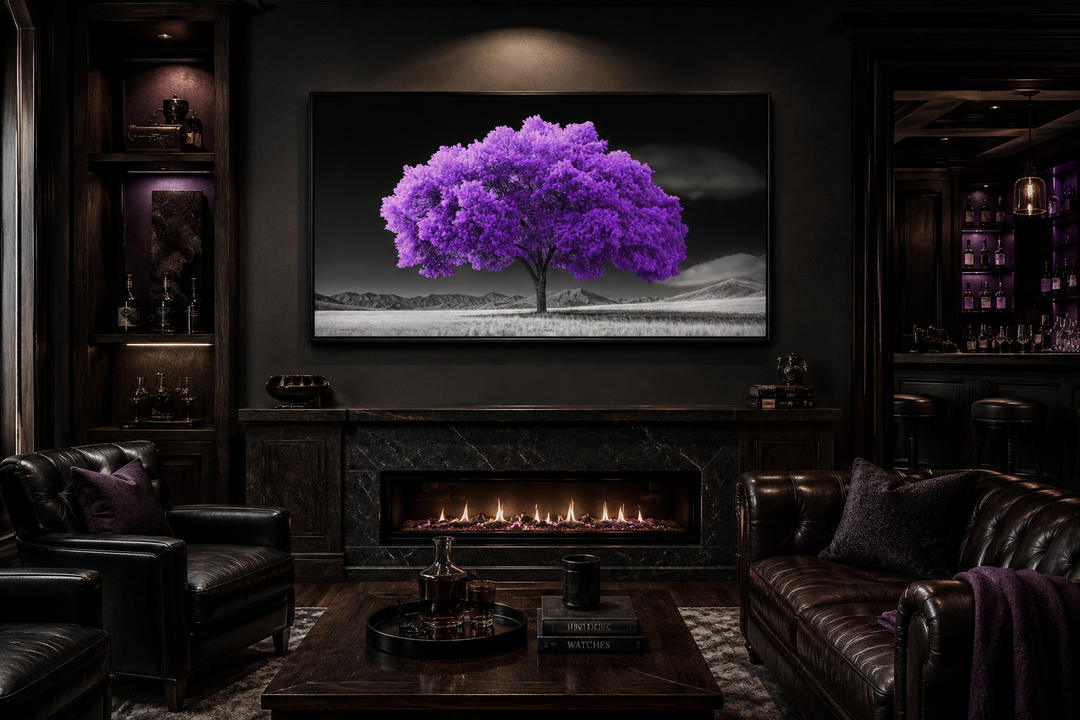 Framed canvas wall art of a vibrant purple tree against a black and white landscape over a fireplace.