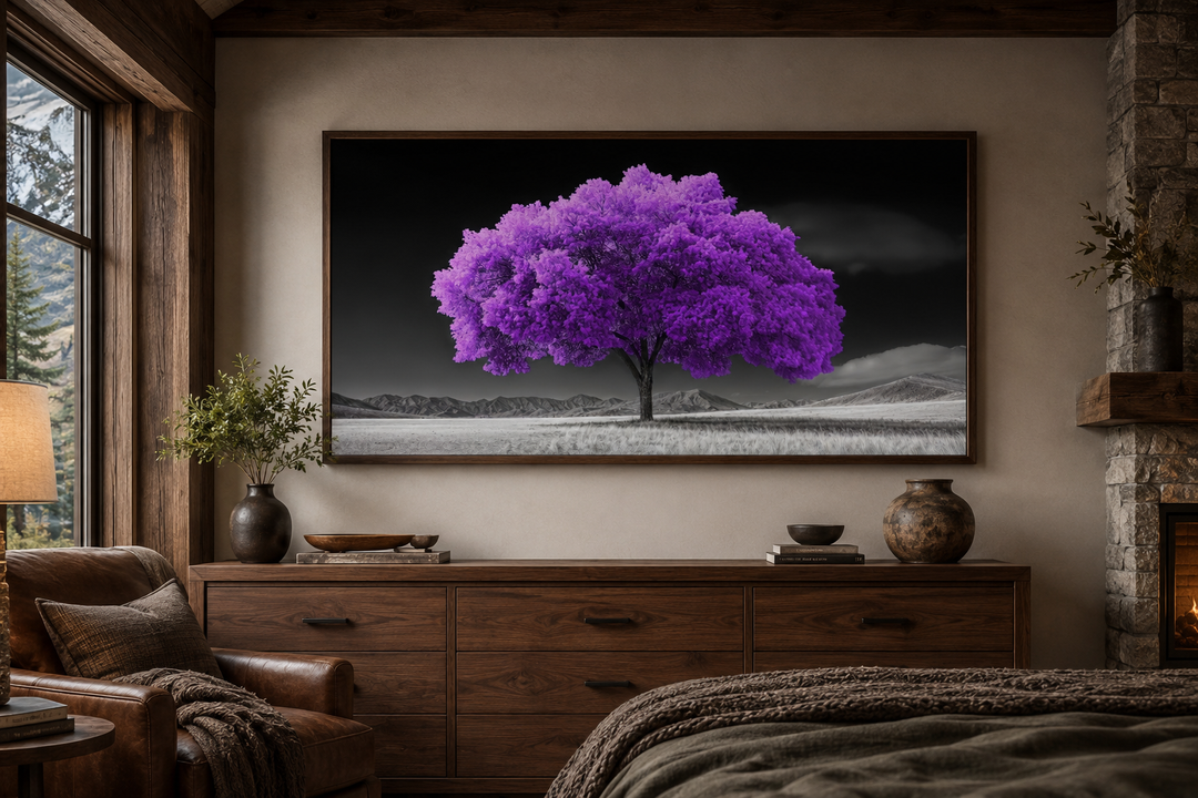 Framed canvas wall art of a vibrant purple tree against a black and white landscape in a bedroom.