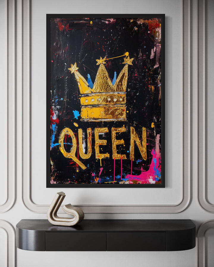 Queen wall art featuring a gold crown and typography on a black background with colorful splatters.