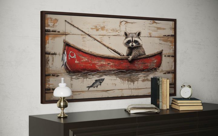 Whimsical raccoon fishing wall art featuring a red boat on a rustic wood-style canvas.