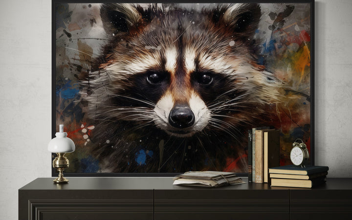 Raccoon modern pop art framed canvas wall art displayed on a dark console table.