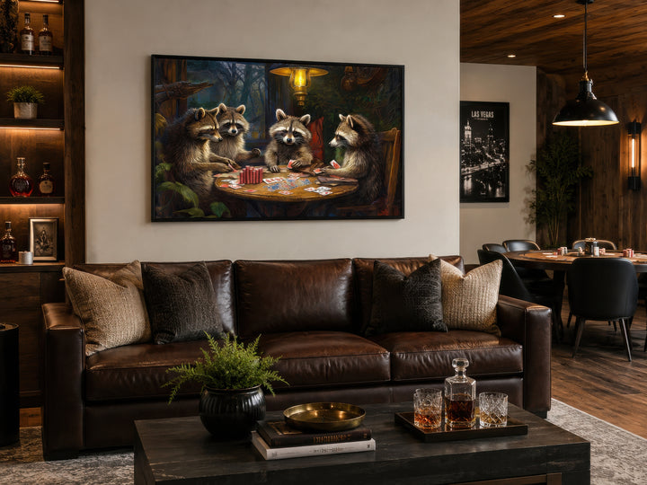 Raccoons playing poker framed canvas wall art hanging above a brown leather sofa in a man cave.
