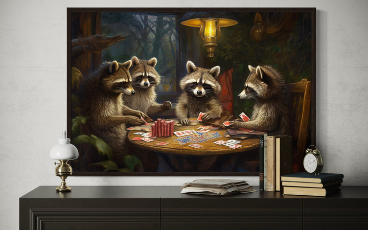 Framed canvas wall art of four raccoons playing poker on a wooden table in a rustic setting.
