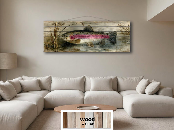 Rustic rainbow trout lake scene wall art printed on distressed wood planks above a neutral sofa.