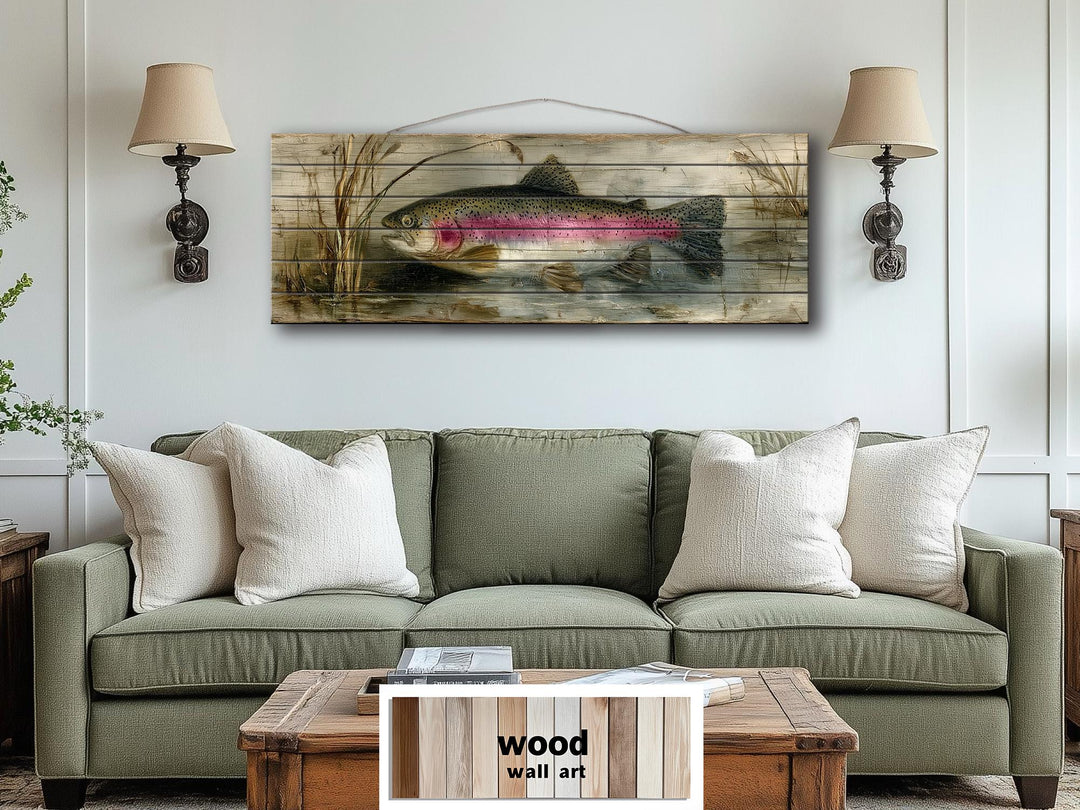Rustic wood wall art featuring a detailed rainbow trout in a lake scene above a green sofa.