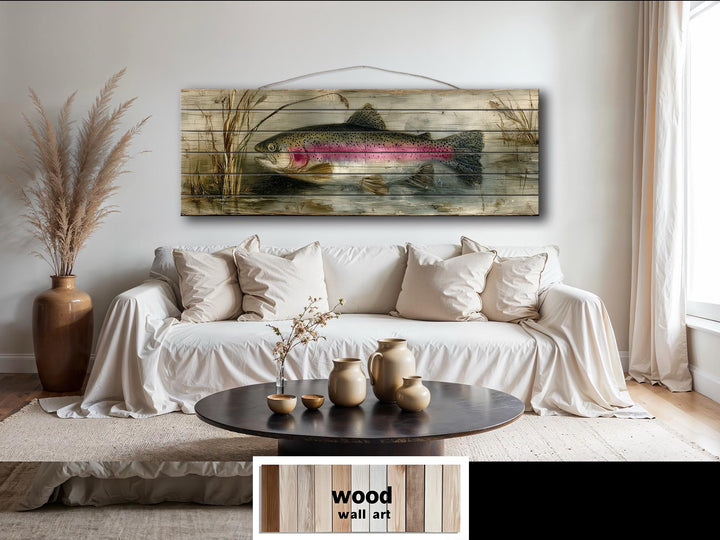 Rustic wood wall art featuring a rainbow trout lake scene hanging above a white sofa.