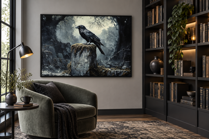 Framed gothic wall art of a black raven on a tombstone in a misty cemetery, in a dark library.