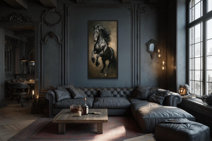 Rearing black stallion framed canvas wall art centered on a dark paneled wall above a leather sofa.
