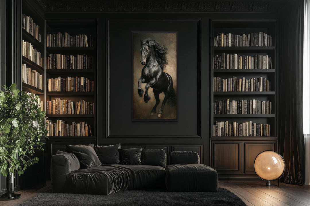 Rearing black stallion framed canvas wall art in a dark library with a black sofa and bookshelves.
