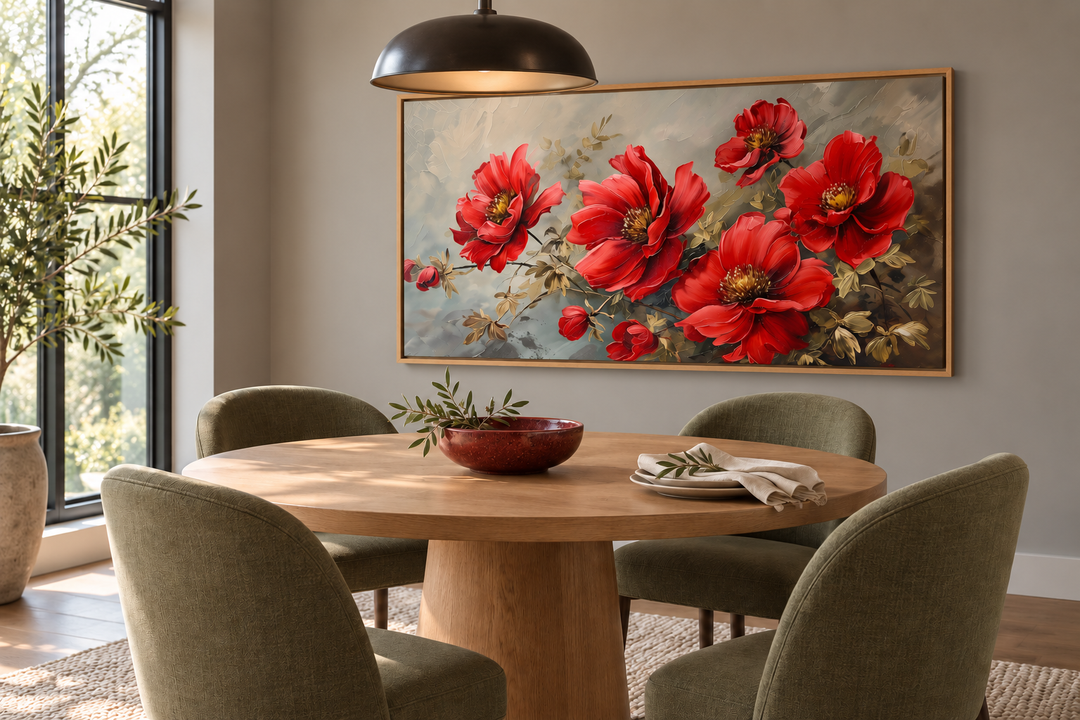 Large framed canvas wall art featuring vibrant red abstract flowers above a round oak dining table.