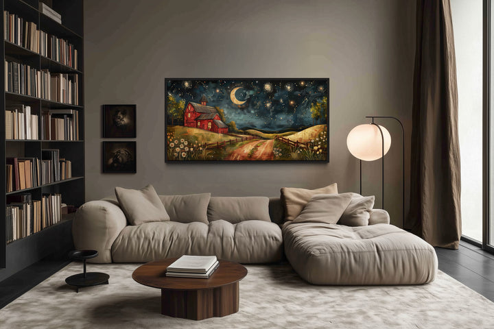 Red barn wall art under a starlit night sky with a crescent moon hanging in a modern living room.