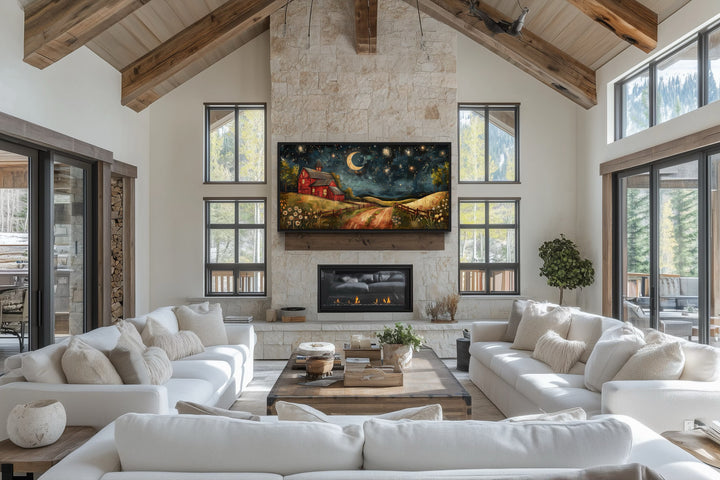 Red barn wall art under a crescent moon and stars displayed above a fireplace in a rustic living room