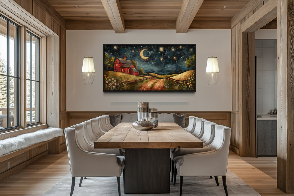 Red barn on a farm at night under stars and a crescent moon wall art in a rustic dining room.