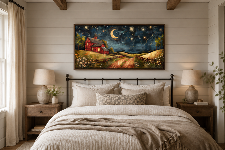 Framed wall art of a red barn under a starry night sky with a crescent moon above a cozy bed.