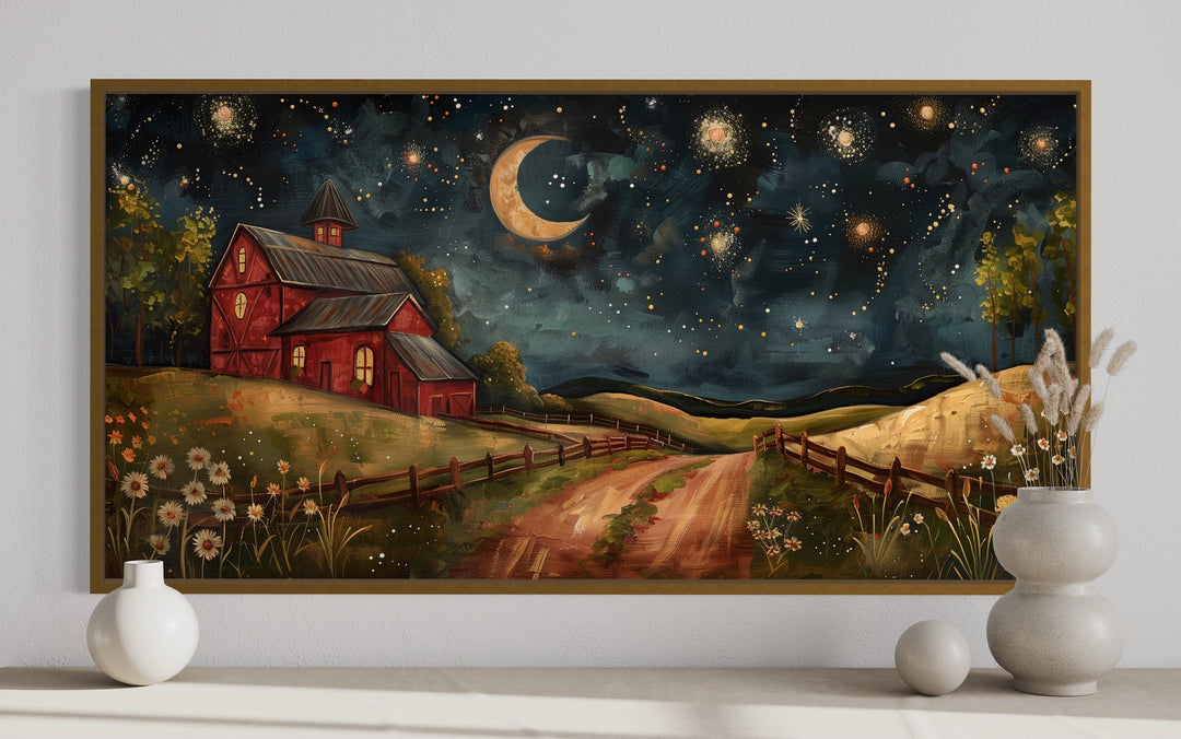 Framed wall art of a red barn on a farm at night under a crescent moon and starry sky.
