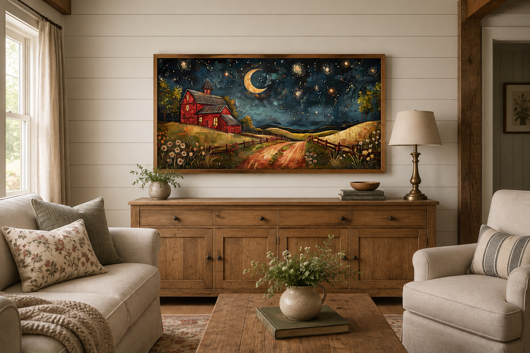 Framed wall art of a red barn under a starry night sky with a crescent moon above a wooden sideboard.