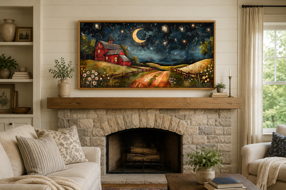 Framed wall art of a red barn under a crescent moon and starry night sky above a stone fireplace.
