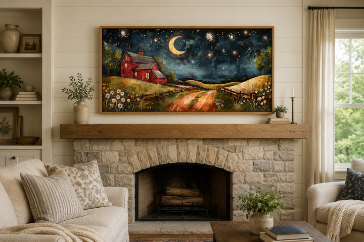 Framed wall art of a red barn under a crescent moon and starry night sky above a stone fireplace.