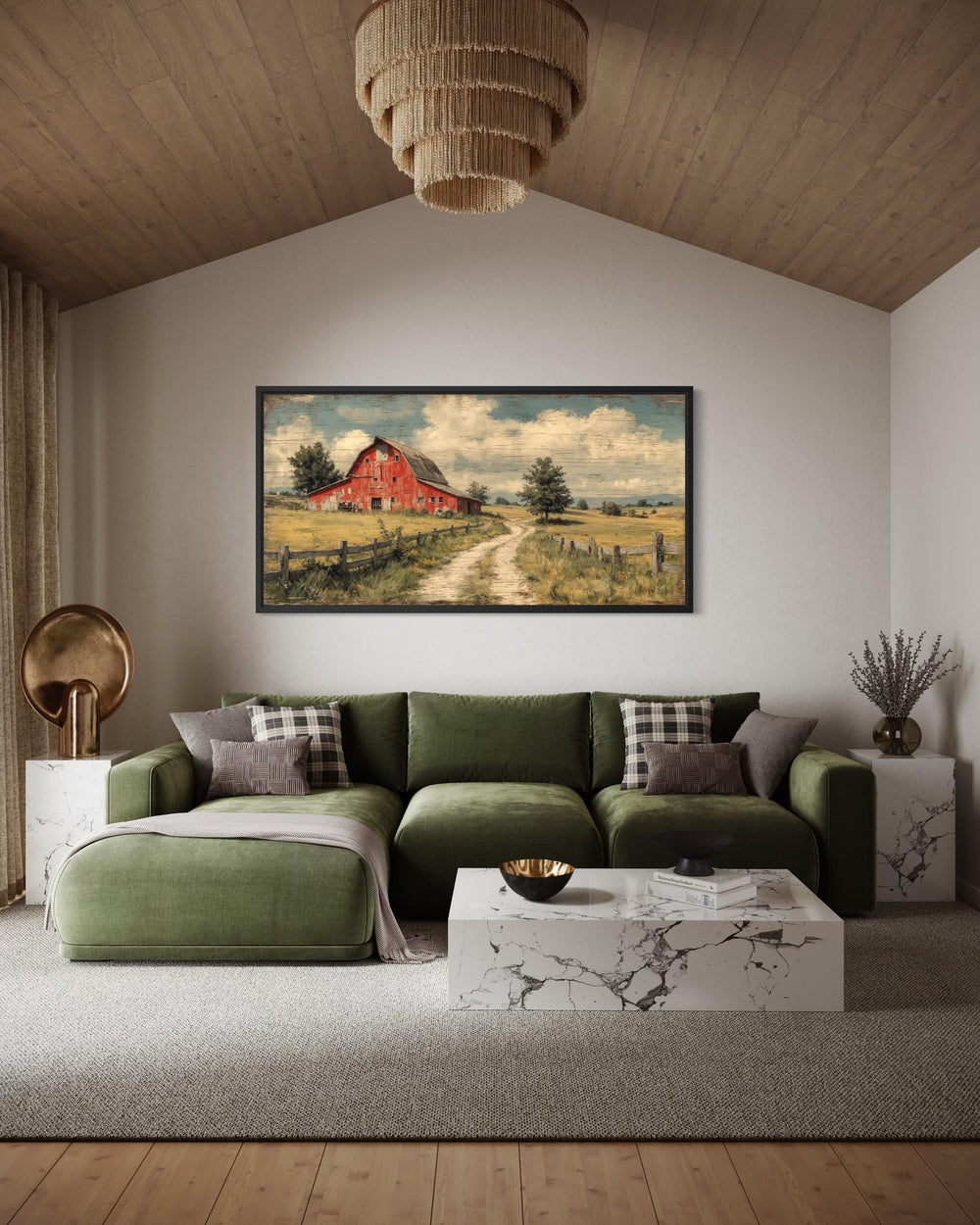 Large horizontal canvas print of a red barn in a rustic landscape above a green velvet sofa.