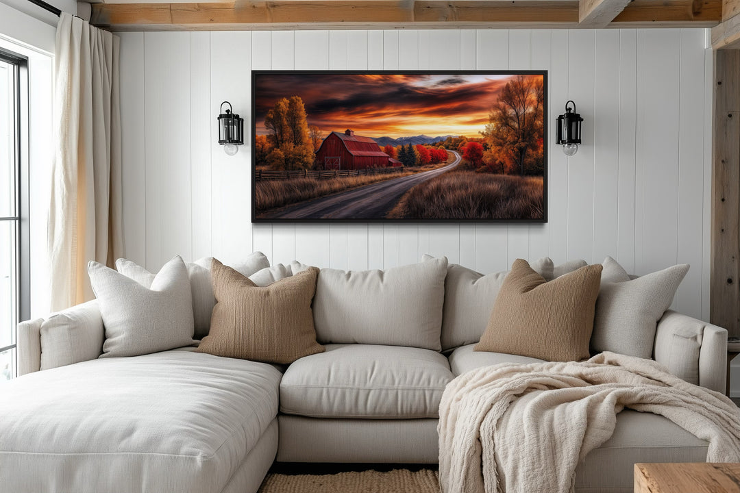 Rustic red barn canvas wall art at sunset hanging above a cozy white sectional sofa.