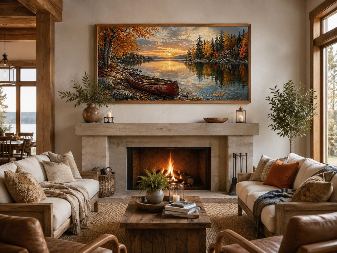 Red canoe on an autumn lake canvas wall art hanging above a fireplace in a rustic living room.
