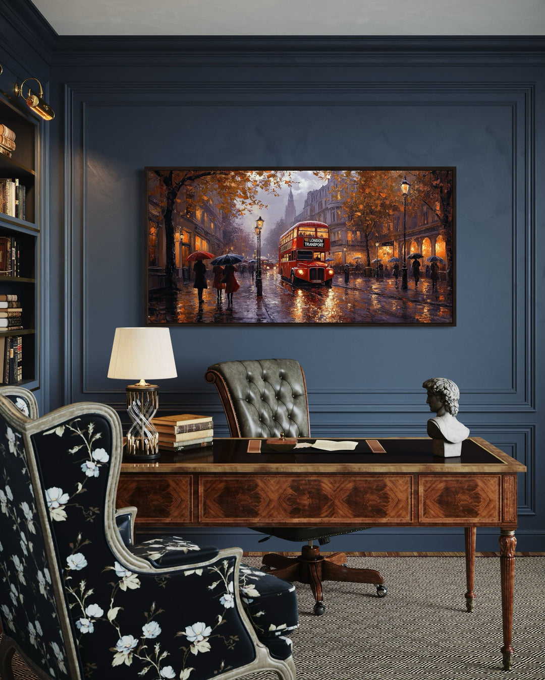 Framed canvas art of a red double decker bus in rainy London above a classic wooden office desk.