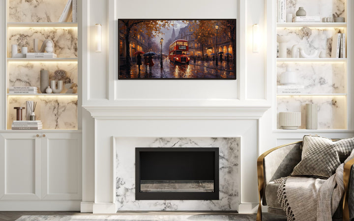 Framed canvas wall art of a red double decker bus in rainy London above a white fireplace.