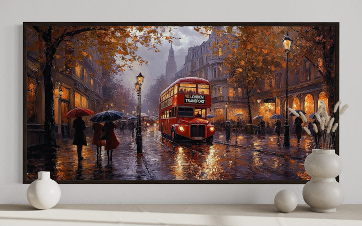 Framed canvas wall art of a red double decker bus on a rainy London street with autumn trees.