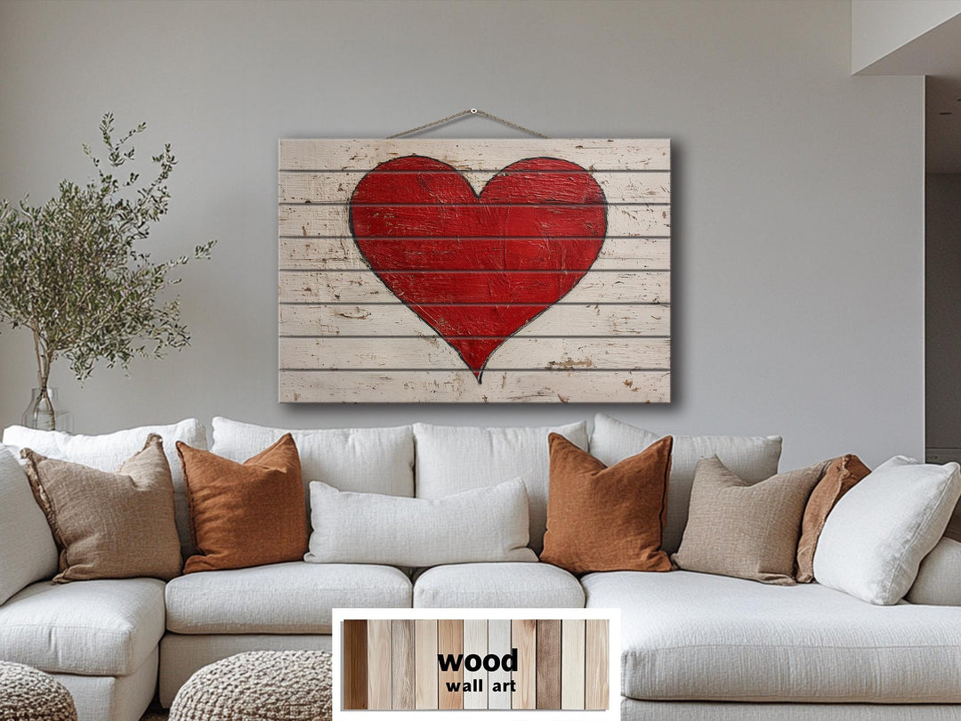 Rustic red heart painted on weathered white wood planks for farmhouse wall decor.